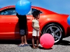 Lannia Gordon, 3, of Grand Rapids admires a 2010 Camaro SS with her big brother, Rydell, 5, left, on Friday, August 28 at Roger's Plaza during the 2010 Foremost 6th annual 28th Street Metro Cruise in Grand Rapids.