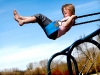 Ashleigh DeWitt, 9, of Comstock Park swings high into the air at Dwight Lydell Park as temperatures continue to remain above average.