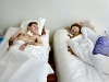 Josh Hoffman, 26, and his fiance, Heather Lovell, 22, lie with their beds pushed together before going to sleep on Wednesday, March 4 in their Middleville home.\