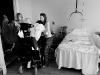 Lovell, on right and LPN nurse Judy Zende help Hoffman into bed at the end of the day. \